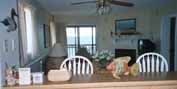 Kitchen Breakfast Bar w/ Dining Area & Living Room in the Background