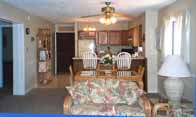 Living Room w/ Dining Area & Kitchen in the Background